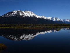 04D Blueberry Hill Reflected In The Water Of A Small Pond From Train After Leaving Whittier For Anchorage Alaska