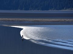 07B A Surfer Rides The Bore Tide Wave Advancing Down Turnagain Arm From Tourist Train Between Whittier And Anchorage Alaska