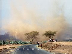 03C A Dust Storm Kicks Up Across The Road On The Drive To Arusha Tanzania To Climb Mount Kilimanjaro