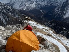 01B Guide Lal Sing Tamang sets up our tent at Lobuche East High Camp 5600m with Ama Dablam and Malanphulan beyond