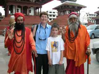 Charlotte Ryan and Peter Ryan pose with two Hindu Sadhus in Kathmandu Durbar Square