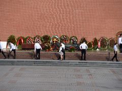 04A Soldiers guard the Tomb of the Unknown Soldier with many wreaths next to the external Kremlin wall and Corner Arsenalnaya Tower Moscow Russia