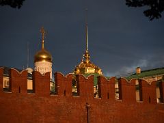 11 A golden onion dome and golden spire beyond the Kremlin wall from Alexander Gardens Moscow Russia
