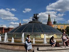 02A Glass cupola crowned by a statue of Saint George with the 4-story Okhotny Ryad shopping mall below and Kremlin beyond Manezhnaya Square Moscow Russia