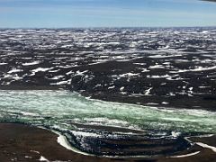 02B Green Coloured Partly Frozen Water And Broad Landscape Just After Taking Off From Iqaluit Airport To Pond Inlet Baffin Island Nunavut Canada For Floe Edge Adventure