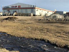08A Co-op Store Outside With A Small Stream And Kids Playing Basketball In Pond Inlet Mittimatalik Baffin Island Nunavut Canada For Floe Edge Adventure