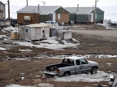 09A A Pick Up Truck In Snow With Some Of The Buildings In Pond Inlet Mittimatalik Baffin Island Nunavut Canada For Floe Edge Adventure