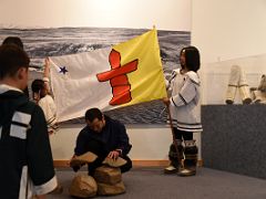 07A Building An Inuksuk With The Nunavut Flag Behind In Pond Inlet Mittimatalik Baffin Island Nunavut Canada For Floe Edge Adventure