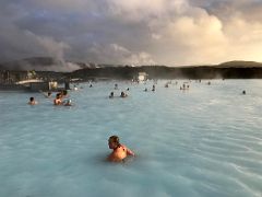 03A We enjoy the hot blue refreshing water highlighted by the low sun with the Svartsengi geothermal power station in the background Blue Lagoon geothermal spa Iceland