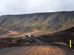 01C Road 42 snakes around green moss covered Vatnshlidarhorn mountain on Reykjanes Peninsula Iceland