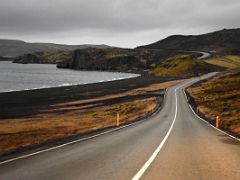 02C Road 42 snakes thru green moss covered lava and around Kleifarvatn lake with the Sydristapi cliff view point ahead Reykjanes Peninsula Iceland