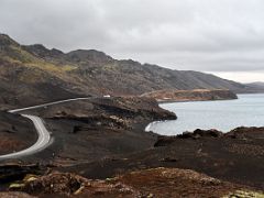 03B Looking north to road 42 snaking around black lava and Kleifarvatn lake with Stapatindur mountain to left from Sydristapi cliff view point Reykjanes Peninsula Iceland