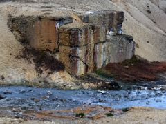 06A A multi coloured large rock next to a boiling hot water stream at Seltun Krysuvík geothermal area Reykjanes Peninsula Iceland