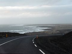 08A The ocean crashes on the Reykjanes south coast with Grindivik in distance from road 427 Reykjanes Peninsula Iceland