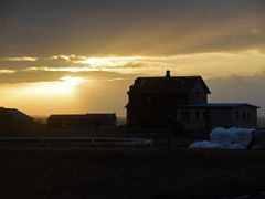 08B A bright sun shines on houses on the outskirts of Grindivik driving on road 427 Reykjanes Peninsula Iceland