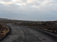 09B We left road 425 and drove down a side road surrounded by lava toward Gunnuhver geothermal area in the distance Reykjanes Peninsula Iceland