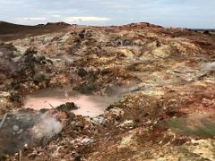 10A Colourful red, green and yellow deposits with hot steam fumaroles at Gunnuhver geothermal area Reykjanes Peninsula Iceland