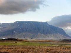 09A Flat topped mountain across the plain driving on road 54 from Borgarnes to Snaefellsnes Iceland