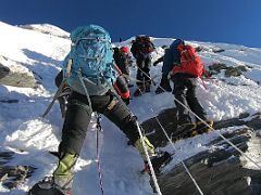 04B Lal Sing Tamang Leads The Way Past Climbers In A Traffic Jam At A Small Rock Band From The Fixed Ropes On The Climb To The Island Peak Summit
