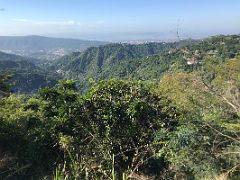 04A We stopped again and could see Kingston is in the distance beyond the green forest covered hills on our way to Blue Mountains near Kingston Jamaica