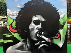 04A Mural of Bob Marley smoking from the cover of Catch a Fire in 1973 at the Bob Marley Museum Kingston Jamaica