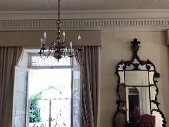 05A The living room has a chandelier and a large decorative mirror Devon House mansion Kingston Jamaica