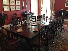 06 The dining room has a Chippendale wooden table and chairs and a decorative carpet Devon House mansion Kingston Jamaica