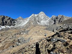 02A Trail crosses the valley and ascends the scree slope on the left from the top of the hill behind Lobuche with Lobuche Peak above on the way to Lobuche East Base Camp