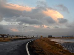 05B Driving thru Rif with the sun shining on the clouds overhead on road 574 on the north coast of Snaefellsnes Peninsula Iceland
