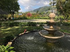 05A A water fountain with the labyrinth beyond in the Sunken Garden in Royal Botanical Hope Gardens Kingston Jamaica
