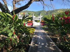 01B The pathway to the Circular Mound is lines with beautiful red flowers Chinese Garden Royal Botanical Hope Gardens Kingston Jamaica