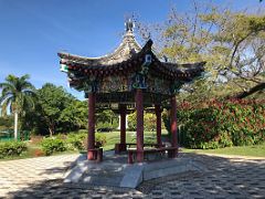 06A A colourful Chinese pagoda is set among beautiful green trees and flowers in the Chinese Garden Royal Botanical Hope Gardens Kingston Jamaica