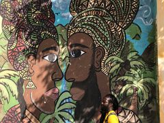 01C Local guide LifeChildArt poses next to his imagined painting of himself and his mother Paint Jamaica street art Kingston Jamaica