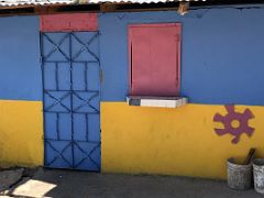 08C A small blue, yellow and pink colourful house on 2nd Street Trench Town Kingston Jamaica