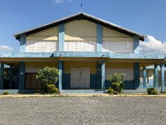 14C A lone large blue and yellow painted building on the north side of 5th Street Trench Town Kingston Jamaica