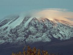 03A The First Rays Of Sunrise On Mount Kilimanjaro Kili As Clouds Form Over The Summit From Moshi Tanzania YMCA In The Pre-Dawn Light On The Way To Climb Kili Kilimanjaro
